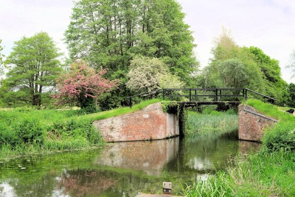 Find a colour photograph of a bridge over a canal.