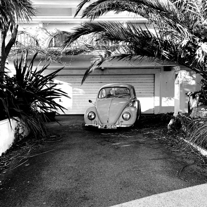 The Blue Beetle Black and white photograph of a blue VW beetle, California style.