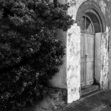 That door Find a black and white photograph of a distressed door.