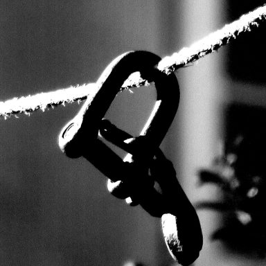 Find a photograph of a clothes line with a weight on it.